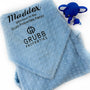Folded minky baby blanket with a custom embroidered business logo in the corner, showcasing a branded company gift.
