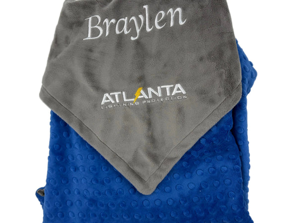 Folded gray and blue blanket with 'Braylen' and 'Atlanta Lightning' branding on a white background