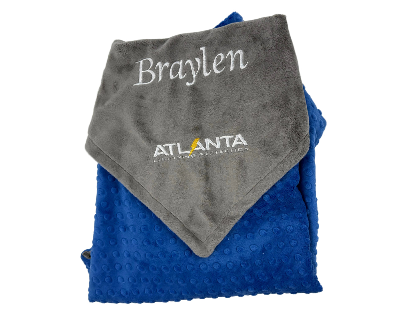 Folded gray and blue blanket with 'Braylen' and 'Atlanta Lightning' branding on a white background