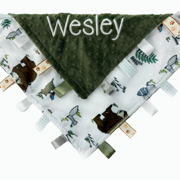 Baby blanket with green minky fabric and animal pattern on a white background