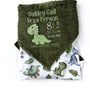 Baby blanket with dinosaur pattern and personalized text on a white background