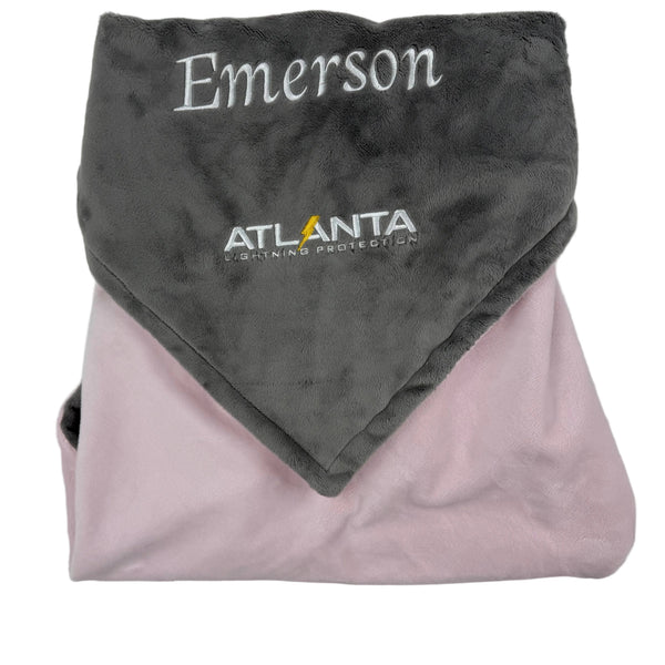 Folded gray and pink blanket with 'Emerson' and 'Atlanta Lightning' branding on a white background