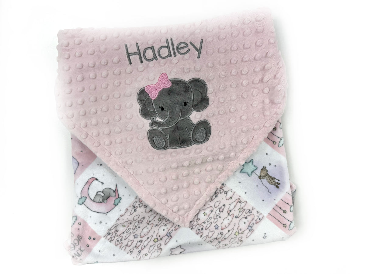 Pink baby blanket with gray elephant design and 'Hadley' text on a white background
