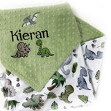 Personalized dinosaur baby blanket with embroidered baby name on sage green dimple minky and colorful dinosaur print backing