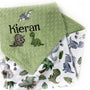 Personalized dinosaur baby blanket with embroidered baby name on sage green dimple minky and colorful dinosaur print backing