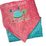 Pink and blue baby blanket with turtle design and 'Thalia Green' text on a white background