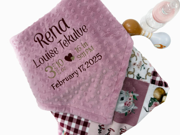 Pink baby blanket with personalized text on a white background