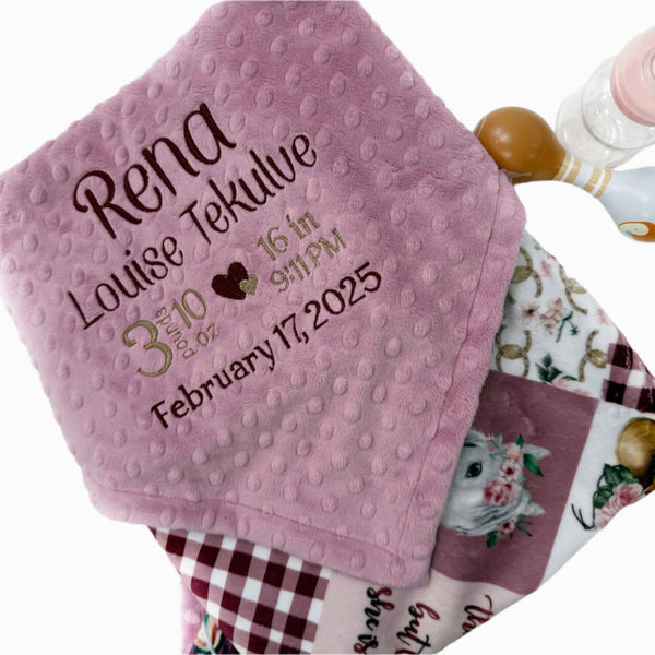 Pink baby blanket with personalized text on a white background