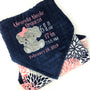 Baby blanket with a gray elephant applique and birth stats in coral and white. Blanket has navy dimple dot on one side with the elephant. The other side is smooth coral and navy floral minky. This is a beautiful soft blanket for baby to snuggle.