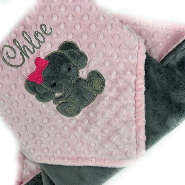 Baby blanket with a gray elephant applique and name in gray. This blanket has blush pink dimple dot on one side with the elephant and name. The other side is smooth graphite gray minky. This is a beautiful soft blanket for baby to snuggle.