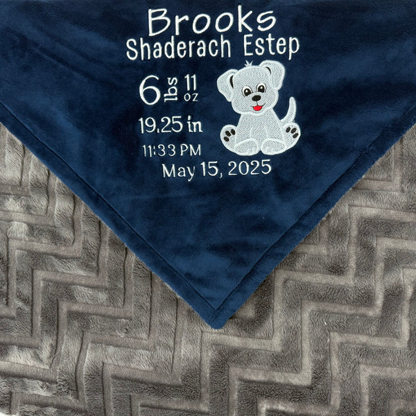 Navy blue and gray blanket with embroidered baby birth stats and a puppy applique in white