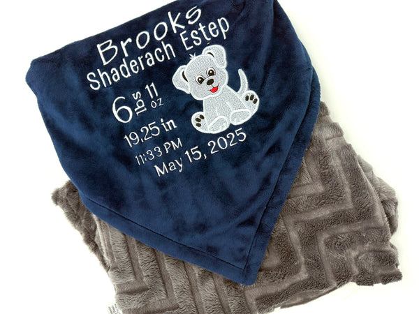 Navy blue and gray blanket with embroidered baby birth stats and a puppy applique in white