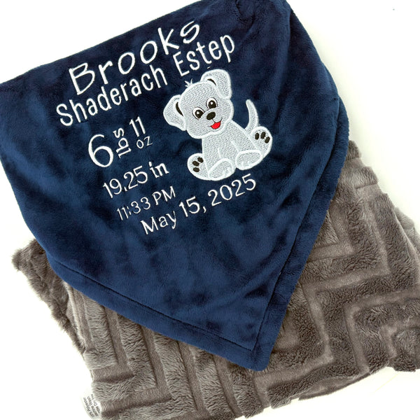Navy blue and gray blanket with embroidered baby birth stats and a puppy applique in white