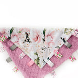 Floral patterned tag blanket with pink accents on a white background