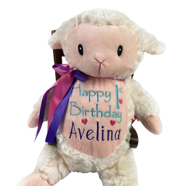 Plush lamb toy with 'Happy 1st Birthday Avelina' text on a white background